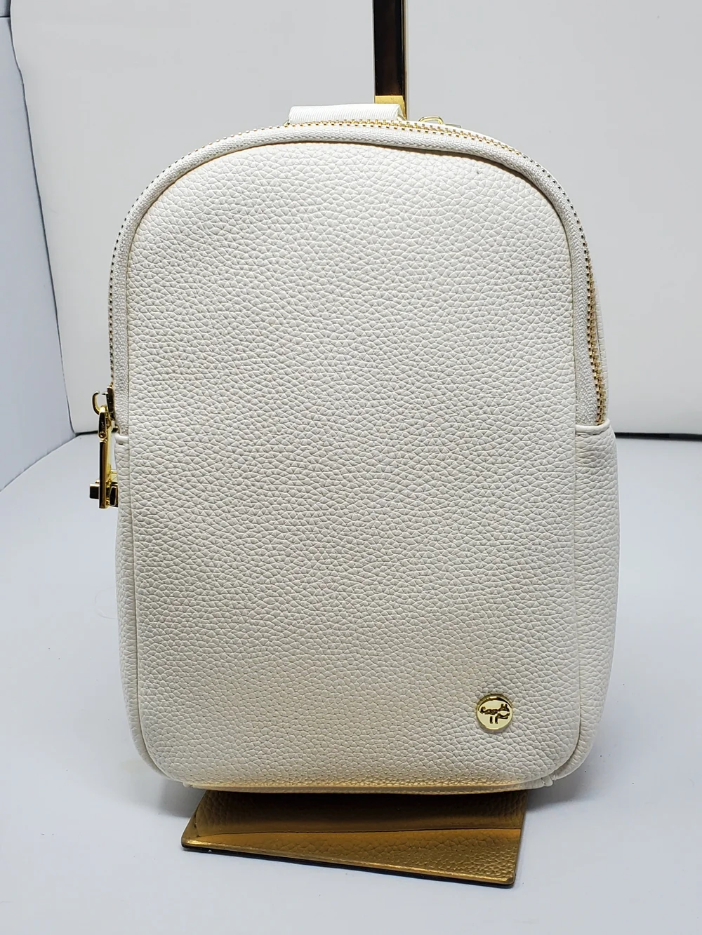 Elegant Pebbled White Crossbody Backpack - Gold Hardware